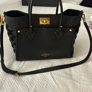 On my side black tote. There is minor damage but still in good condition
